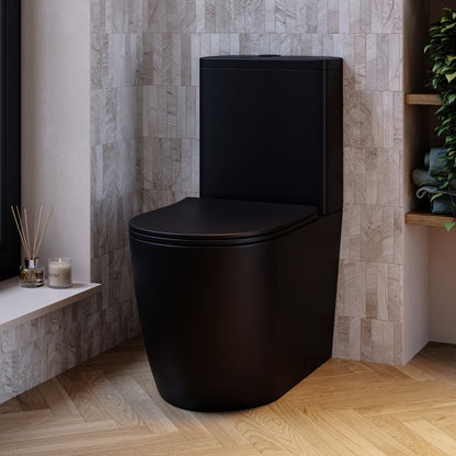 Black toilet in a bathroom with tiled walls and wooden floor.